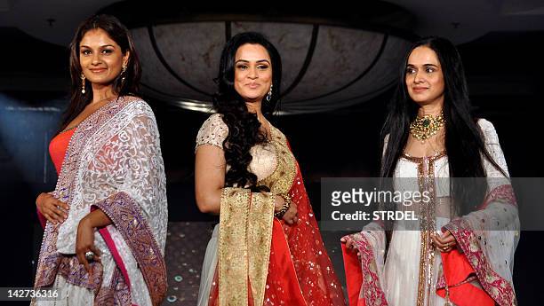 Indian Bollywood actress Padmini Kolhapure and her sister Tejaswini Kolhapure and Shivangi Kapoor display creations by designer Manish Malhotra for a...