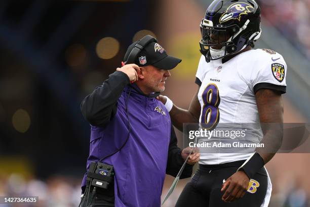 Lamar Jackson of the Baltimore Ravens speaks with head coach John Harbaugh during the game against the New England Patriots at Gillette Stadium on...