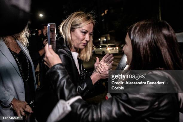 Conservative party Brothers of Italy President Giorgia Meloni greets a supporter after casting her vote at a polling station on September 25, 2022 in...