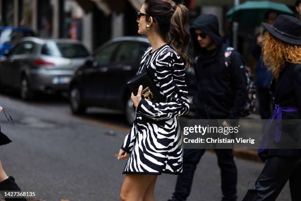 Guest wears zebra print dress, bag outside Dolce & Gabbana during the Milan Fashion Week - Womenswear Spring/Summer 2023 on September 24, 2022 in...