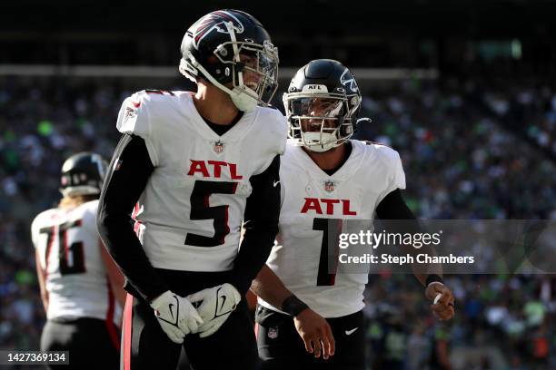 Drake London and Marcus Mariota of the Atlanta Falcons celebrate after a touchdown against the Seattle Seahawks during the third quarter at Lumen...