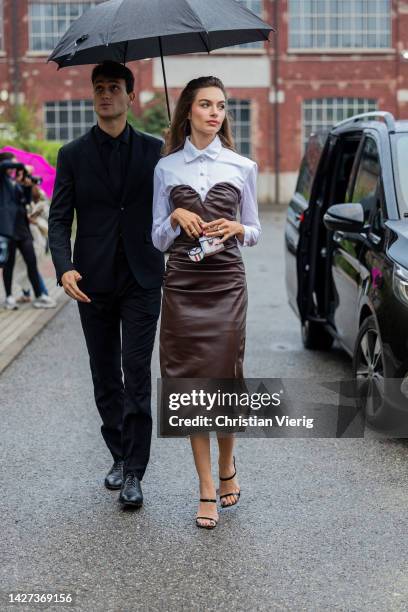 Guest wears brown dress, white button shirt outside Bally during the Milan Fashion Week - Womenswear Spring/Summer 2023 on September 24, 2022 in...