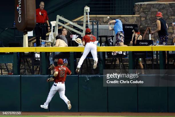 Alek Thomas of the Arizona Diamondbacks attempts to catch a solo home run hit by J.D. Davis of the San Francisco Giants during the ninth inning at...