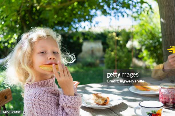 happy girl eating melon for breakfast in the garden - fruits été photos et images de collection