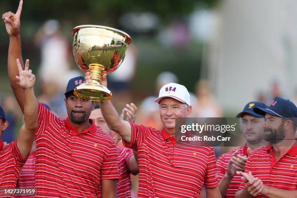 Captain Davis Love III of the United States Team celebrates with the Presidents Cup alongside the team during the closing ceremony after defeating...