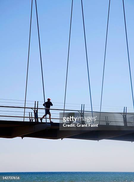 jogger on bridge. - running toronto stock pictures, royalty-free photos & images