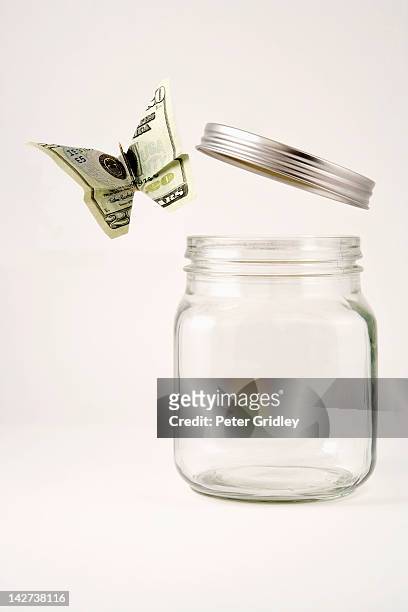 twenty dollar butterfly flying out of a glass jar - releasing stock pictures, royalty-free photos & images