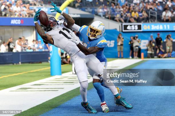 Marvin Jones Jr. #11 of the Jacksonville Jaguars catches a touchdown over Michael Davis of the Los Angeles Chargers during the fourth quarter at SoFi...