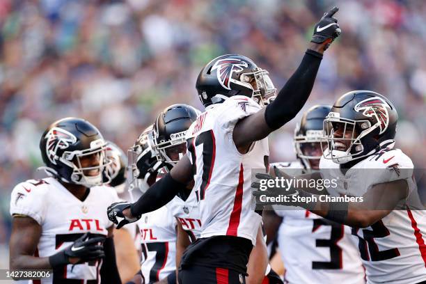 Richie Grant of the Atlanta Falcons is congratulated by Jaylinn Hawkins after making an interception against the Seattle Seahawks during the fourth...