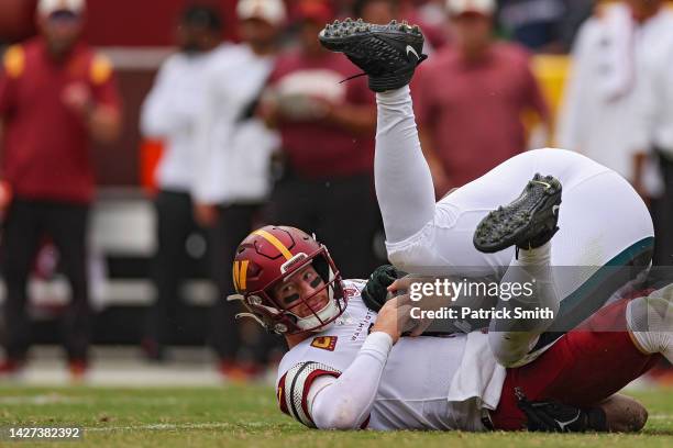 Defensive tackle Javon Hargrave of the Philadelphia Eagles tackles quarterback Carson Wentz of the Washington Commanders during the second half at...