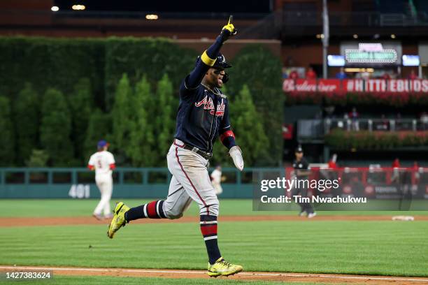 Ronald Acuna Jr. #13 of the Atlanta Braves rounds bases to score during the eleventh inning against the Philadelphia Phillies at Citizens Bank Park...