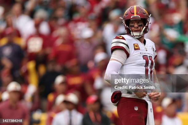 Carson Wentz of the Washington Commanders reacts after the Commanders turned the ball over on downs in scoring position during the fourth quarter...