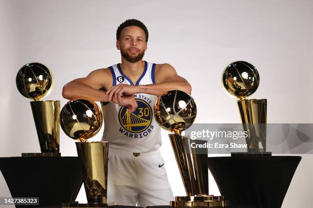 Stephen Curry of the Golden State Warriors poses with the four Larry O'Brien Championship Trophies that he has won with the Warriors during the...