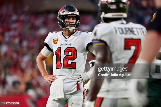Tom Brady of the Tampa Bay Buccaneers talks with Leonard Fournette of the Tampa Bay Buccaneers after missing the two point conversion against the...