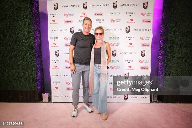 Abby Wambach and Glennon Doyle pose on the pink carpet at Banc of California Stadium on September 25, 2022 in Los Angeles, California.