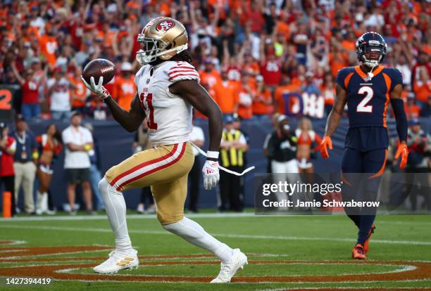 Brandon Aiyuk of the San Francisco 49ers celebrates after scoring a touchdown during the first half against the Denver Broncos at Empower Field At...