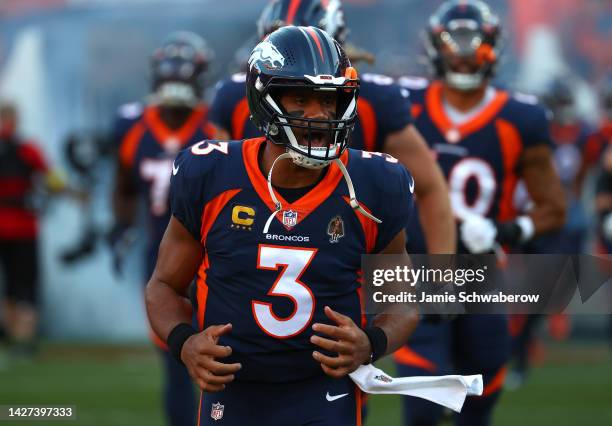 Russell Wilson of the Denver Broncos runs out prior to the game against the San Francisco 49ers at Empower Field At Mile High on September 25, 2022...