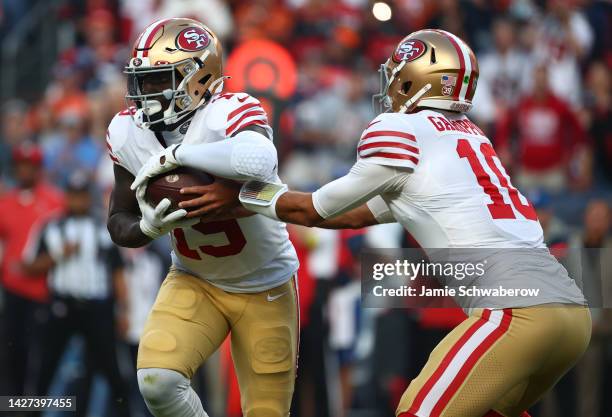 Jimmy Garoppolo of the San Francisco 49ers hands off to Deebo Samuel during the first half against the Denver Broncos at Empower Field At Mile High...