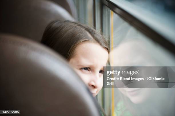 caucasian girl riding school bus - out bus window stock pictures, royalty-free photos & images