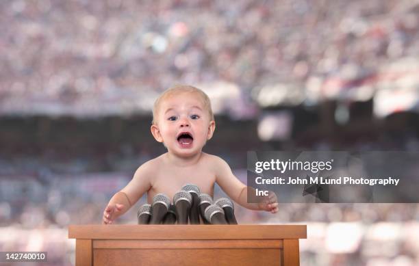 caucasian baby speaking at podium - microphone press conference stock pictures, royalty-free photos & images