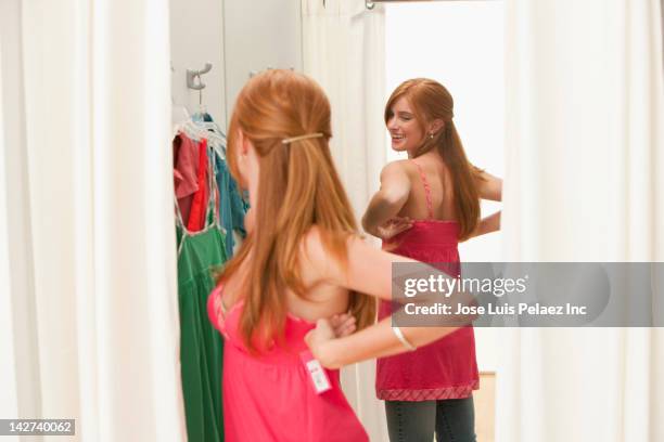 caucasian teenage girl in dressing room - girl changing room shop stock pictures, royalty-free photos & images