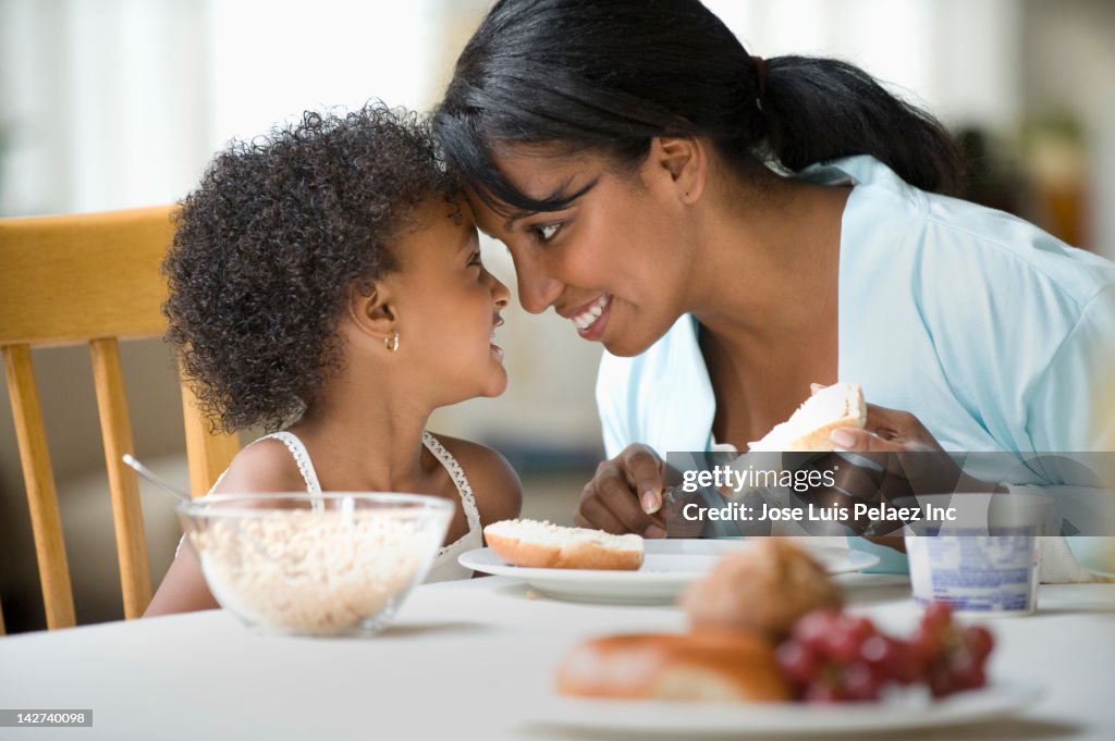 Mother and daughter eating breakfast