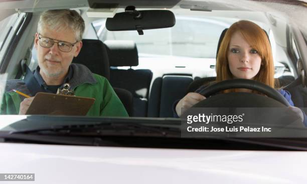caucasian woman taking driver's test - driving instructor stock pictures, royalty-free photos & images