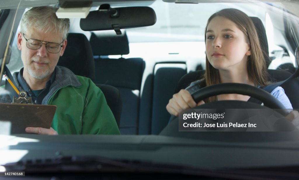 Caucasian teenage girl taking driver's test