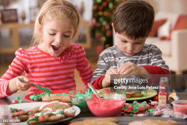 children making christmas cookies - gingerbread biscuit stock pictures, royalty-free photos & images