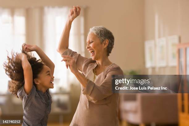 grandmother and granddaughter dancing together - gran ストックフォトと画像