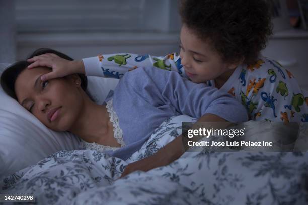 son waking up sleeping mother - wake up foto e immagini stock