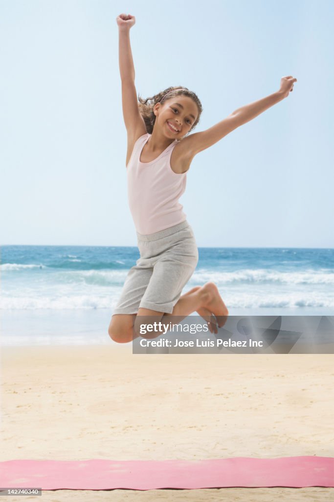 Girl jumping on beach