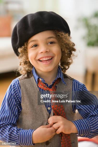 smiling mixed race boy wearing cap - beret stock pictures, royalty-free photos & images