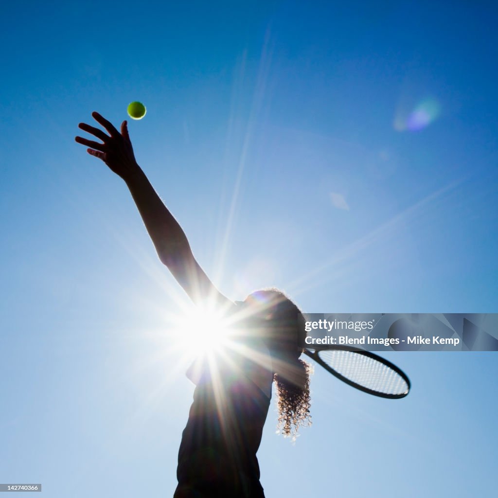 Caucasian woman playing tennis