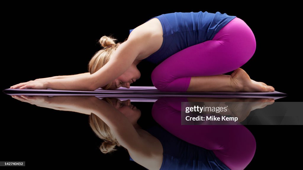 Caucasian woman practicing yoga