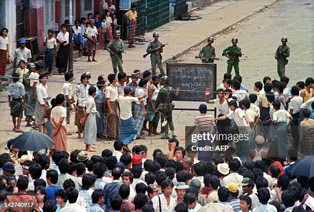 Troops order a crowd 26 August 1988 in downtown Rangoon to disperse in front of sule pagoda sealed off by barbed wires. Hundreds of thousand people...