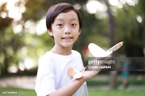 young boy playing with airplane toy - kid pilot stock pictures, royalty-free photos & images