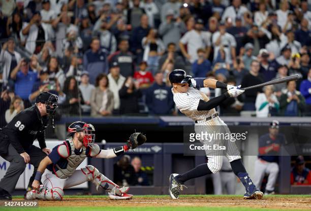 Aaron Judge of the New York Yankees flies out in the fifth inning as Connor Wong of the Boston Red Sox looks on at Yankee Stadium on September 25,...