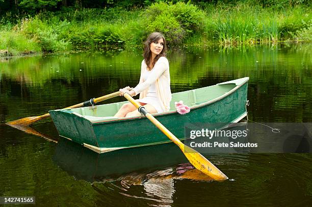 caucasian woman rowing boat in pond - rowboat stock pictures, royalty-free photos & images