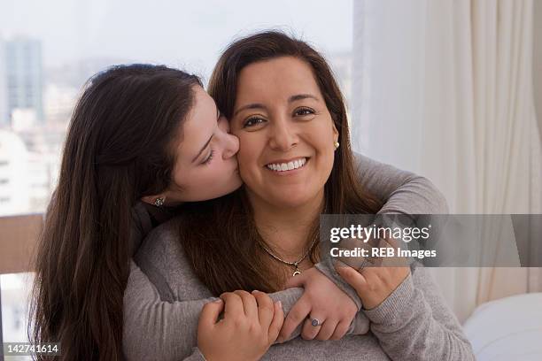 chilean daughter kissing mother - chilean ethnicity stock pictures, royalty-free photos & images