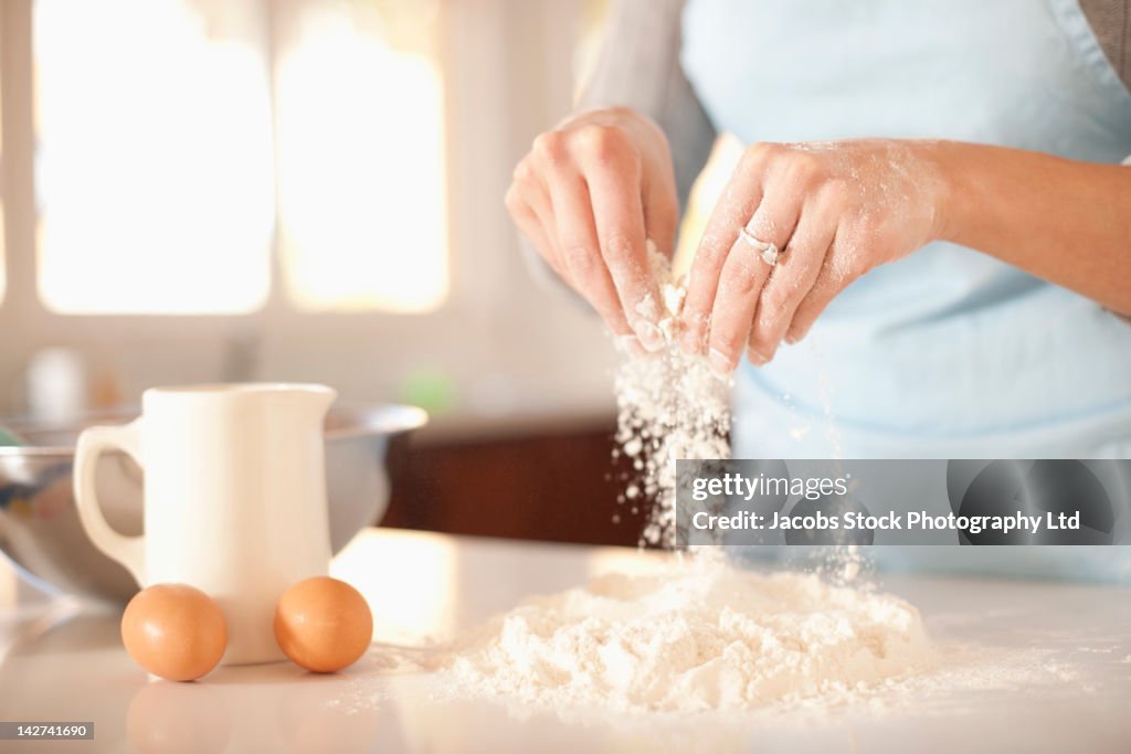 Hispanic woman baking in kitchen