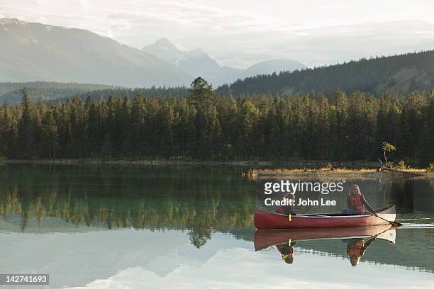 caucasian mother and daughter canoeing on lake edith - boat side view stock pictures, royalty-free photos & images