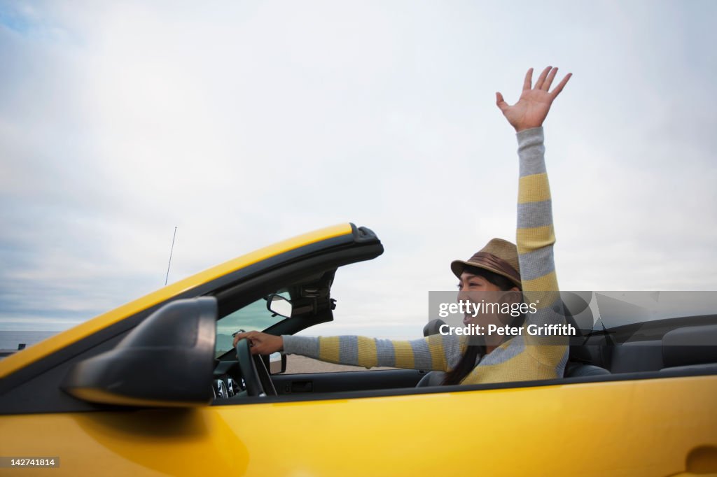 Chinese woman driving convertible
