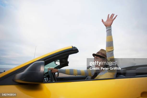 chinese woman driving convertible - person waving stock pictures, royalty-free photos & images