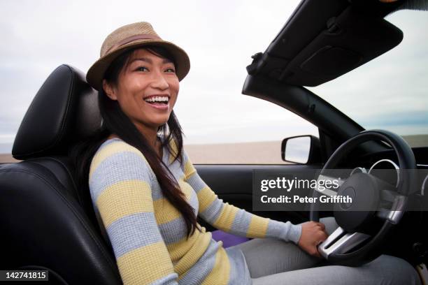 chinese woman driving convertible - chevrolet cabriolet stock pictures, royalty-free photos & images