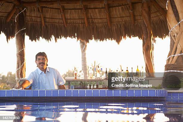 hispanic bartender working near poolside - rooftop pool imagens e fotografias de stock