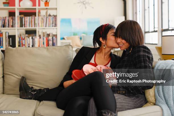 girlfriends sitting together with valentine candy - valentines african american 個照片及圖片檔