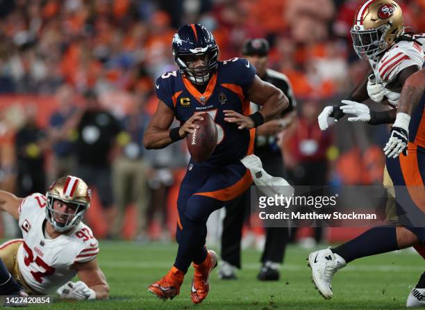 Russell Wilson of the Denver Broncos rushes during the first half against the San Francisco 49ers at Empower Field At Mile High on September 25, 2022...