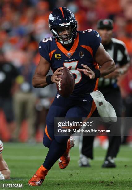 Russell Wilson of the Denver Broncos rushes during the first half against the San Francisco 49ers at Empower Field At Mile High on September 25, 2022...