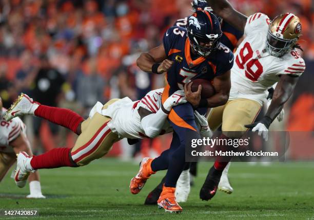 Russell Wilson of the Denver Broncos rushes during the first half against the San Francisco 49ers at Empower Field At Mile High on September 25, 2022...